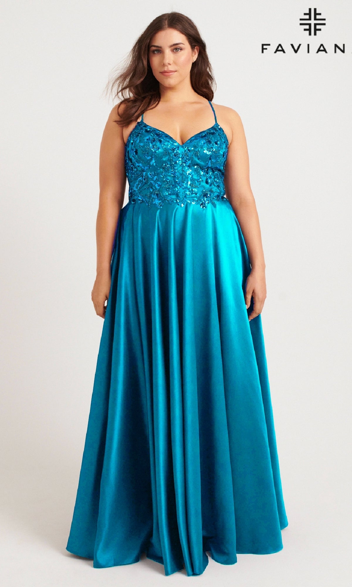 A woman wears the Faviana 9578 long plus-size prom dress, featuring a teal sequin-embroidered bodice and thin straps, against a plain background. The